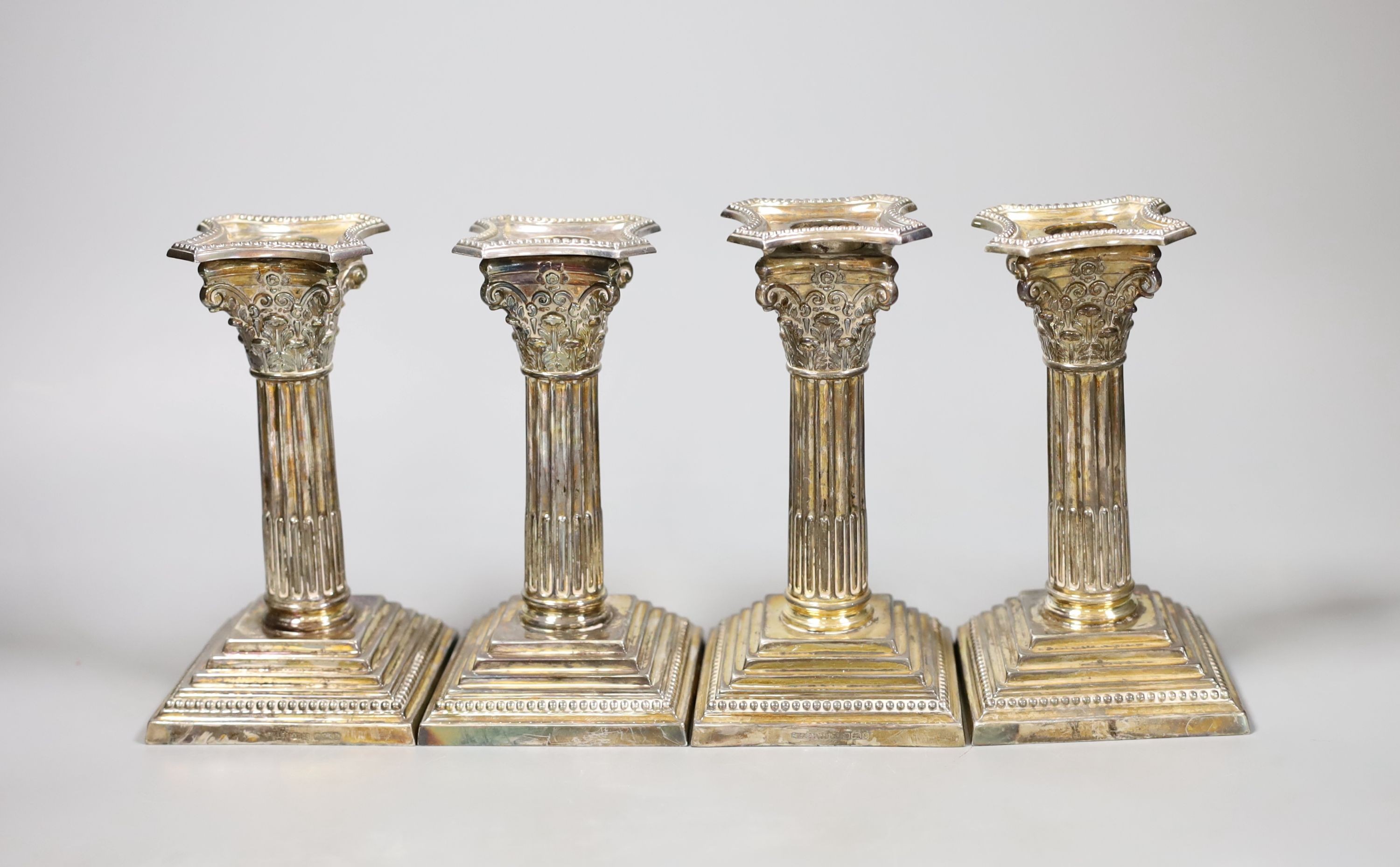 A set of four modern silver Corinthian column dwarf candlesticks, James Dixon & Sons, Sheffield, 1972, weighted, 14.5cm.